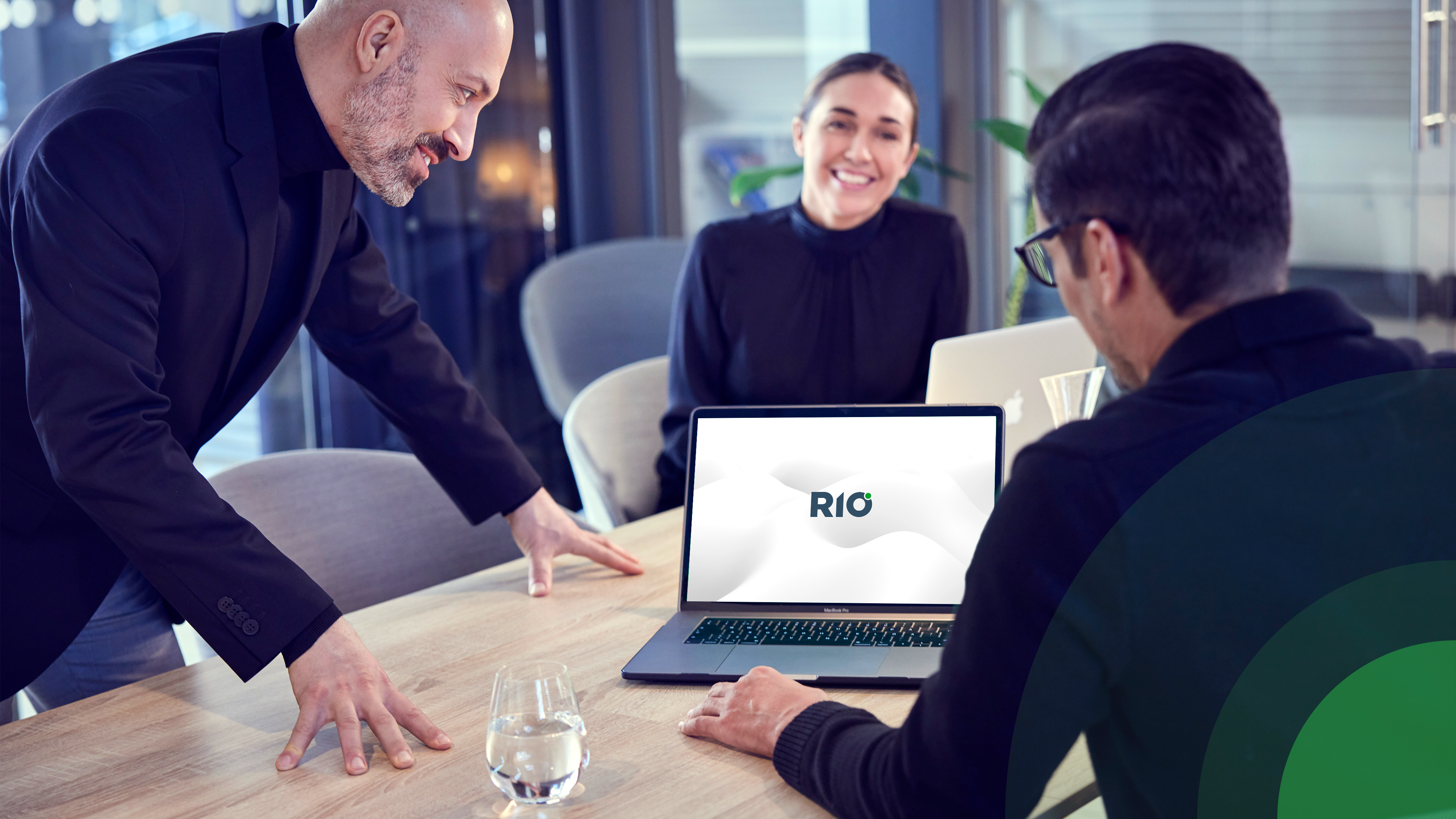 RIO team looking at a laptop with the RIO logo